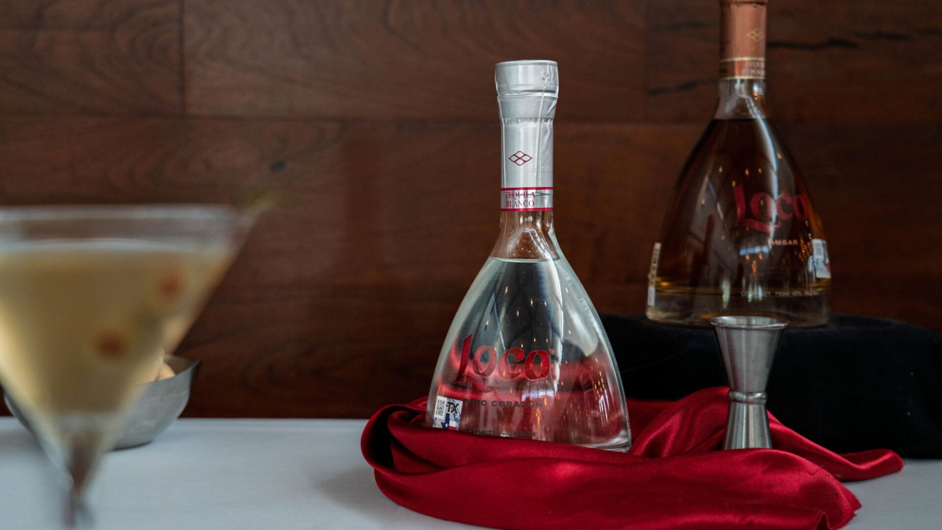 Bottles of Loco Blanco and Loco &Aacute;mbar tequila with a Mexican martini