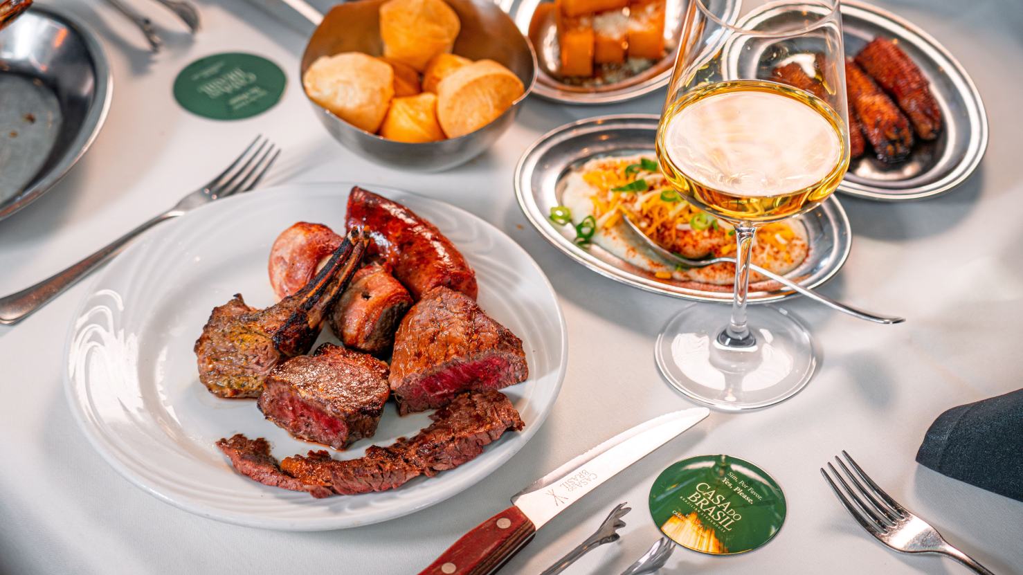 A gaucho chef serves turkey tableside to a family gathered for Thanksgiving at Casa do Brasil