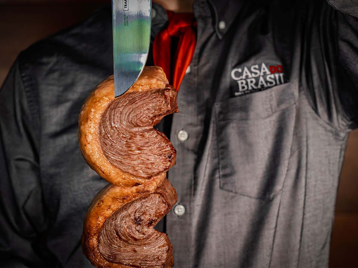 Gaucho chef carving picanha tableside