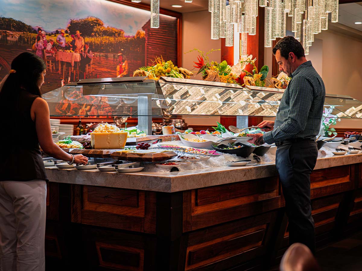 Guest serving herself at the Casa do Brasil salad bar